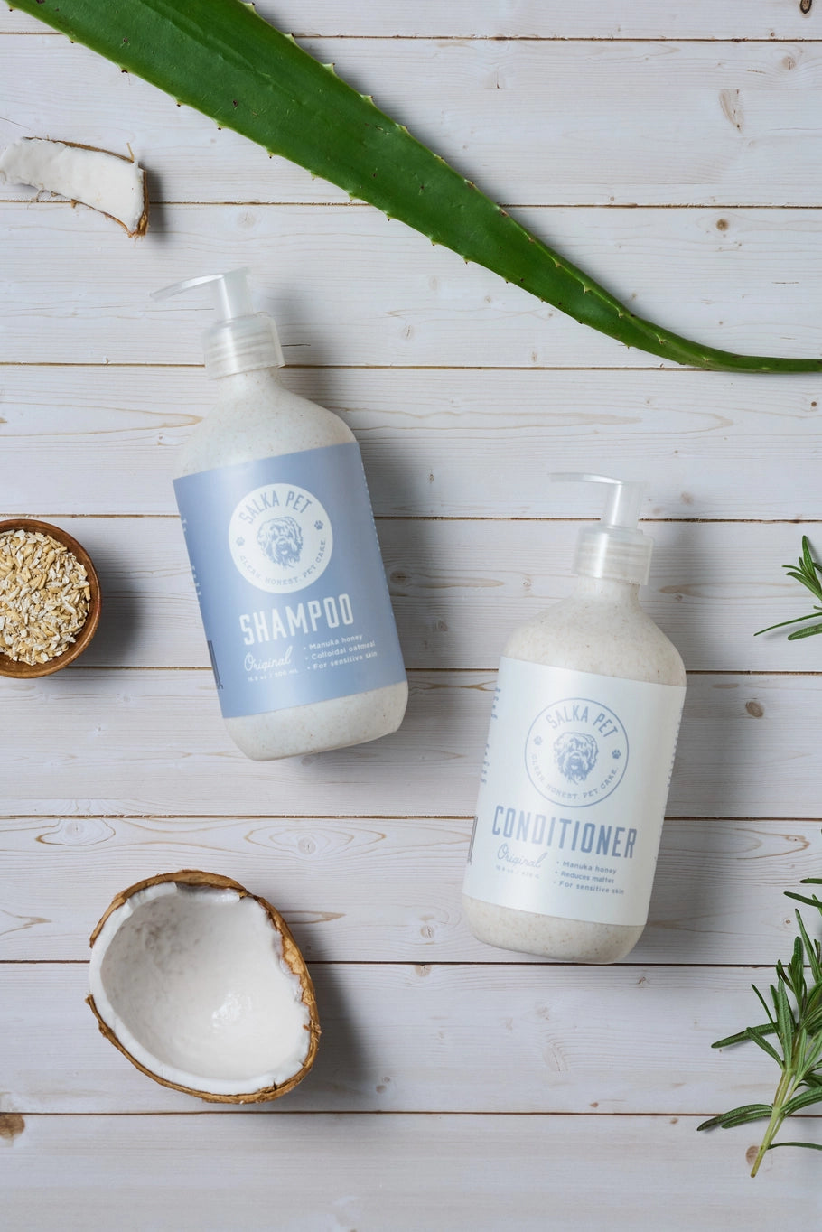 Shampoo and conditioner bottles with natural elements on a wooden surface